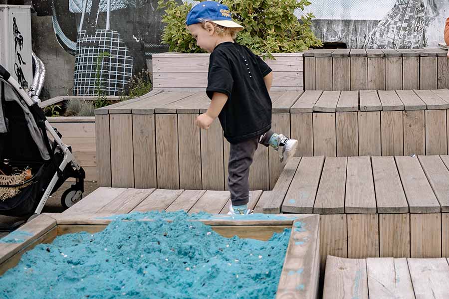 baby playing in sand pit image